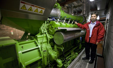 A view of a green Jenbacher gas engine with man at Edinburgh Universities CHP facility