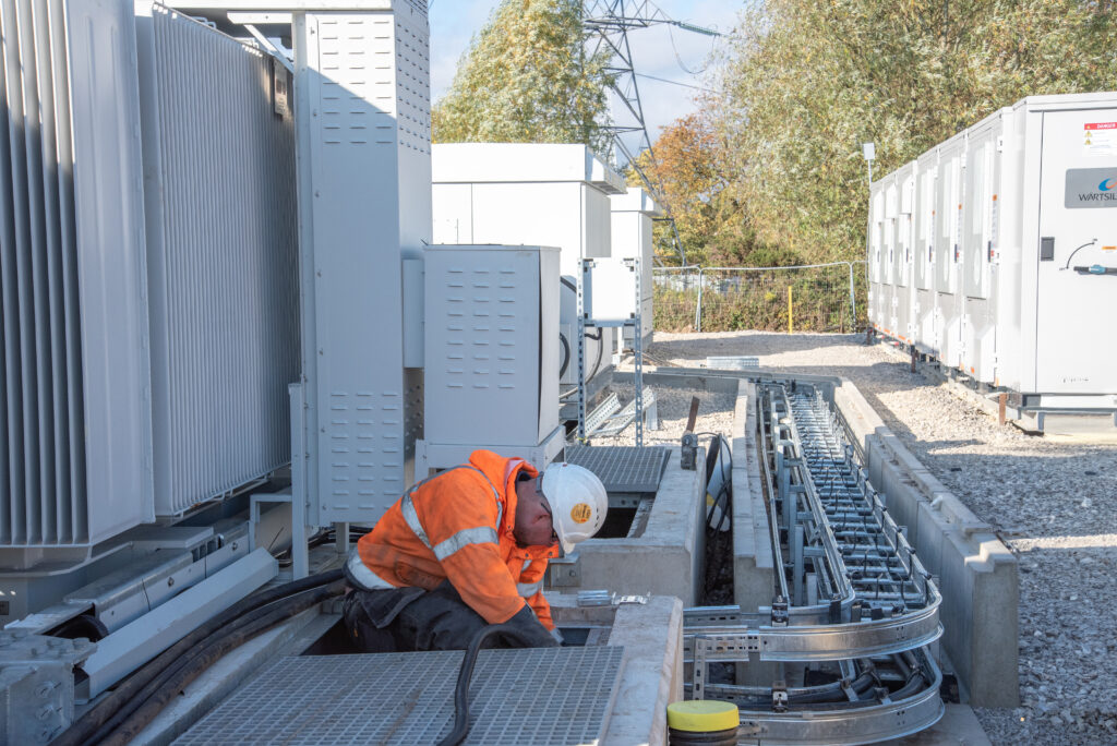 A workman commissioning a BESS system