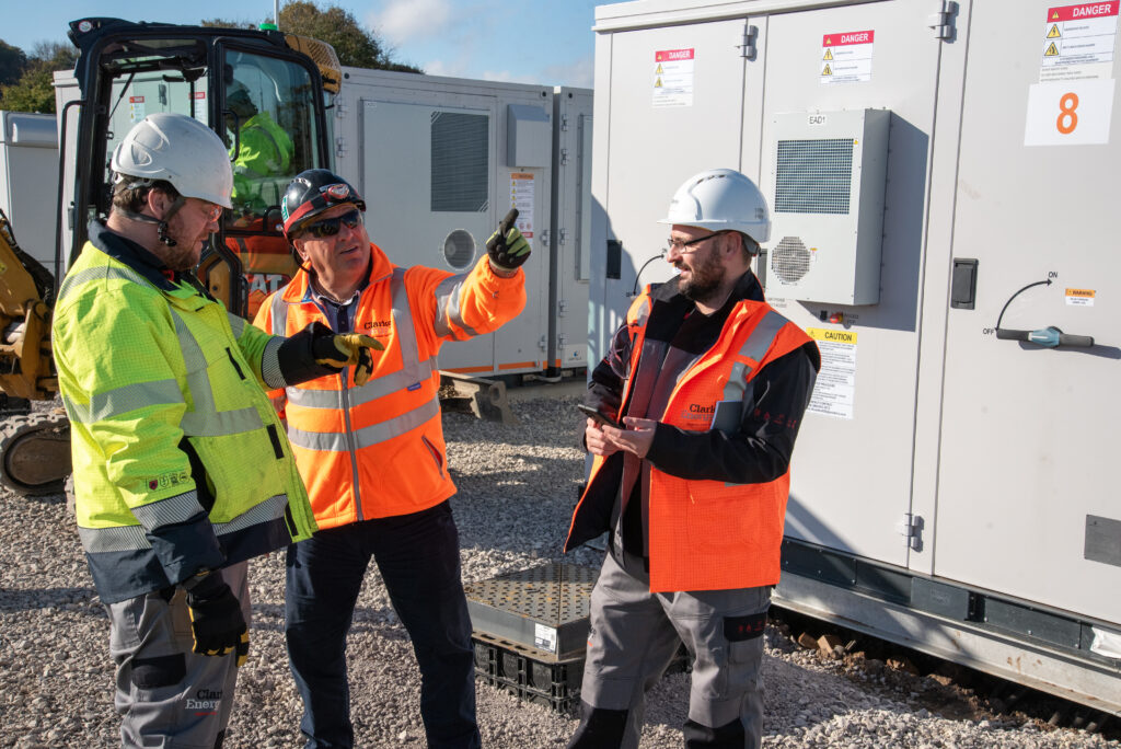 Image shows three Clarke Energy engineers amongst BESS site