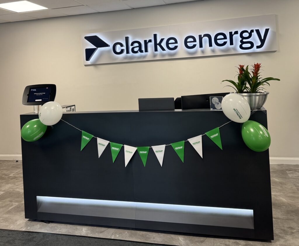 Image is of Clarke Energy UK office reception with Macmillan bunting and balloons for the coffee morning
