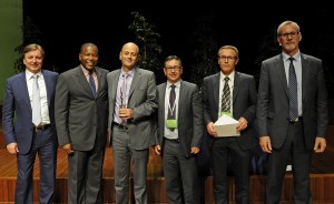 Photo of Clarke Energy France collecting award from GE Jenbacher executives at awards ceremony